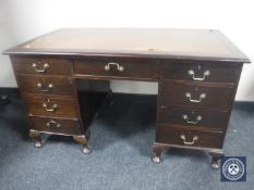 An Edwardian mahogany twin pedestal writing desk with tooled leather panel