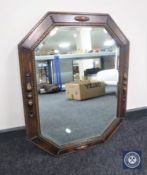 An early 20th century oak octagonal bevelled mirror
