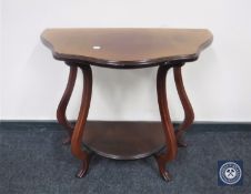 A shaped mahogany two-tier hall table