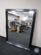 A black framed overmantel mirror