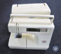 A Memory Craft 5000 cased electric sewing machine (lacking foot pedal),