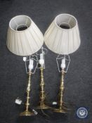 Three brass table lamps and two shades