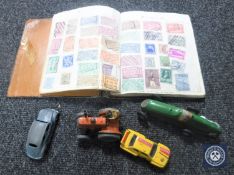 A mid 20th century city stamp album together with four die cast vehicles,