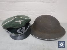 A WWII British helmet and a German cap CONDITION REPORT: The German cap is a
