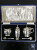 A cased Lindisfarne silver three-piece cruet set, with spoons,