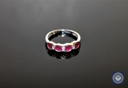 A ruby and diamond half-eternity ring,