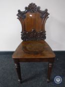 A Victorian carved mahogany hall chair