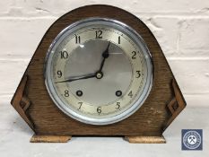 An oak cased Garrard mantel clock with silvered dial,