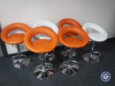 Six leather gas lift bar stools (four orange two white)