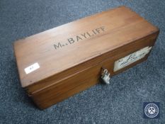 A mahogany box with key bearing the name "Mrs Bayliff"