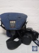 A Canon Eos 1000 F camera with lens in carry bag