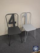 A pair of metal French style cafe chairs