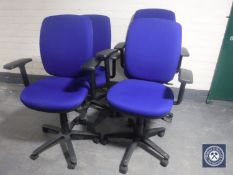 A set of four blue adjustable swivel typists armchairs