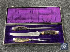 A boxed carving set with silver ferrules by Henry Elliott 7 sons,