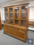 An oak Stag four door bookcase CONDITION REPORT: 199cm high by 180cm wide by 46cm