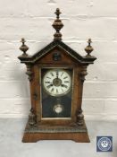 A walnut cased American mantel clock with pendulum and key