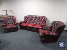A red buttoned leather Chesterfield three piece suite