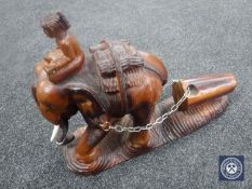 An Eastern hardwood carving of a figure on an elephant