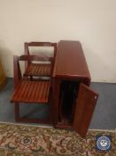 A drop leaf storage kitchen table and four chairs