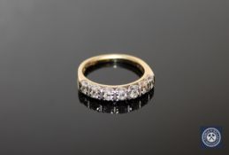 An 18ct gold seven stone diamond half eternity ring, the total diamond weight estimated at 0.