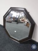 An early 20th century octagonal oak framed bevelled mirror