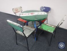 A circular metal dining table with four chairs,