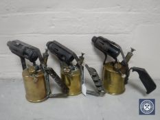 Three early 20th century brass blow lamps by Burmos,