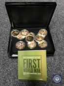 Eleven gold-plated and enamelled coins commemorating the Centenary of the First World War, cased,