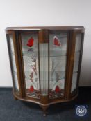 A walnut shaped-front display cabinet