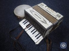A Hohner Student 1 accordion and a tambourine