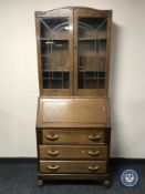 A 20th century oak bureau bookcase with leaded glass doors