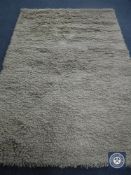 A hand knotted shaggy beige rug, 180 cm x 270 cm, rrp £681.