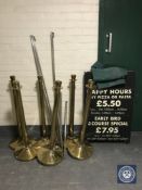 Six brass bollards with poles and covers together with a folding restaurant chalk board