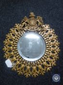 A metal framed mirror bearing The Royal Coat of Arms