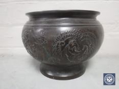 A bronze Japanese planter decorated with dragons, height 15.