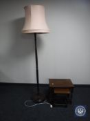 A nest of three oak tables together with a mahogany standard lamp with shade