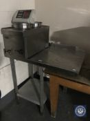 A stainless steel two-tier prep table together with a Parry stainless steel two pot bain marie and