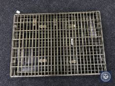 A folding metal dog cage