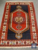 A fringed Caucasian design rug on blue ground,