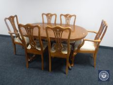 A yew wood extending dining table and six chairs