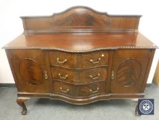 A late Victorian mahogany serpentine fronted sideboard, on claw and ball feet, width 152 cm.
