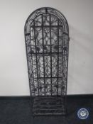 A metal arched topped wine rack