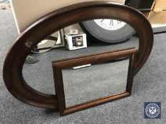 An oval mahogany framed mirror together with another mirror