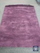 A hand tufted shaggy purple rug, 160 cm x 230 cm,