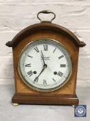 An inlaid mahogany cased Comitti of London bracket clock raised on brass feet