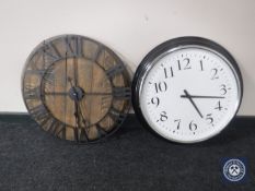 A contemporary station style wall clock and a wall clock on an oak barrel lid