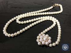 A pearl and 9ct gold double strand necklace