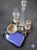 A tray of mid 20th century stainless steel tea service, cased cutlery, glass decanter, oil lamp,