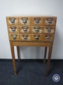A 20th century twelve drawer index chest on stand CONDITION REPORT: 112cm high by