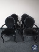 A set of four black French style salon armchairs